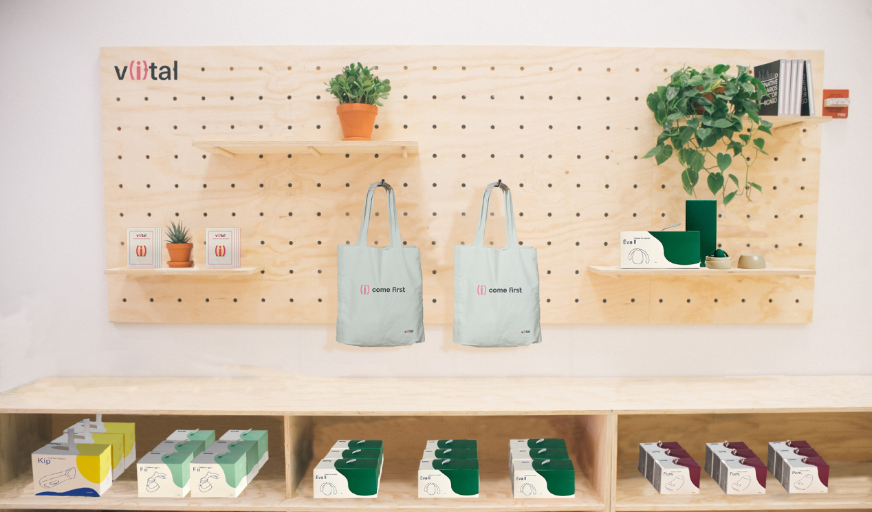 V(i)tal product display wall with tote bags and packaged products